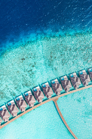 Picturesque aerial landscape luxury tropical island resort water villas. Beautiful beach sunny sea sky. Amazing bird eyes view in Maldives paradise tourism. Exotic best vacationの写真素材