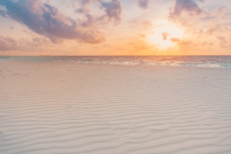 Closeup sea sand beach. Panoramic landscape. Inspire tropical beach seascape horizon. Sand texture waves sunset sky calmness tranquil relax sunlight summer. Vacation travel holidayの写真素材
