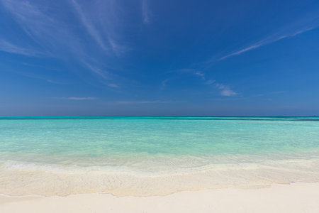 Tropical sunny beach view. Calm sunshine relaxing empty shore, blue sky happy clouds white sand. Tranquil nature shore coast landscape. Seaside beachfront horizon seascape sunlightの写真素材