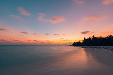 Beautiful panoramic sunset tropical paradise beach. Tranquil summer vacation holiday landscape. Tropical tourism beach seaside palm calm sea exotic nature view inspire seascapeの写真素材