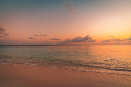 Relaxing waves splash. Idyllic sunset sea sand sky closeup beach landscape for background or wallpaper. Design of tourism for summer vacation holiday destination.の写真素材