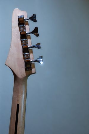 Detail of a base guitar arm (from behind).Detail of a base guitar (from behind). Blueish lighting in the background.の写真素材
