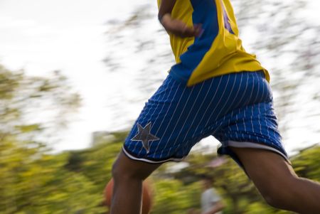 Detail of unrecognisable basketball players with park-like background.の写真素材