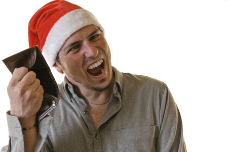 Angry young man with Santa hat holding an empty wallet and making barking mad face. White...