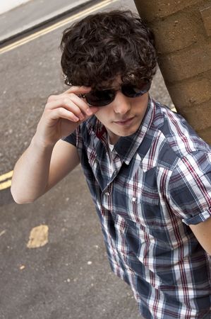 High angle street portrait of young man wearing glassesの写真素材