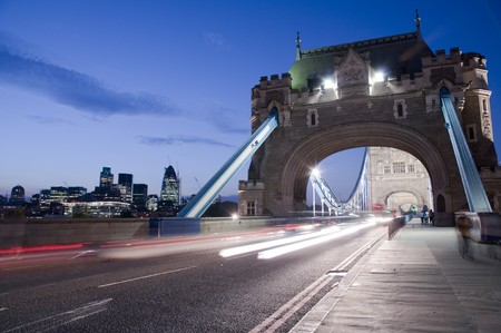 Detail of Tower Bridge in London at dusk with car light trail and city in the background.の写真素材