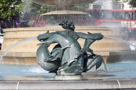 Detail of statue by water fountain in Trafalgar Square, central London, UKの写真素材