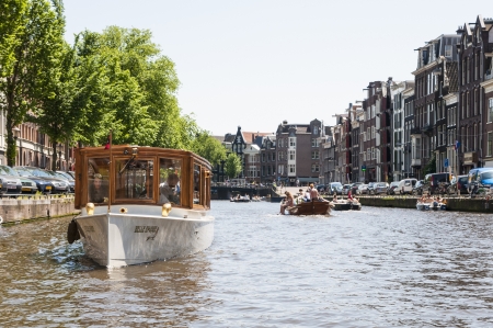 AMSTERDAM, HOLLAND - MAY 27: Private boat in one of the main canals in the city centre. May 27, 2012 in Amsterdam.のeditorial素材