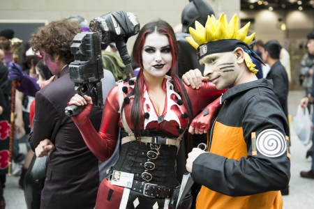 LONDON, UK - OCTOBER 28: Cosplayers impersonating Naruto and Harley Quinn pose for photographers at...