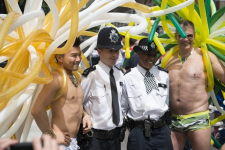 LONDON, UK - JUNE 29: Participants at the gay pride posing for pictures in their balloons outfit with police constables. June 29, 2013 in London.のeditorial素材