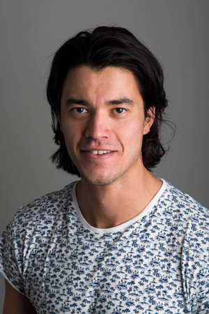 Portrait of handsome Malaysian man wearing flowery top and smilingの写真素材
