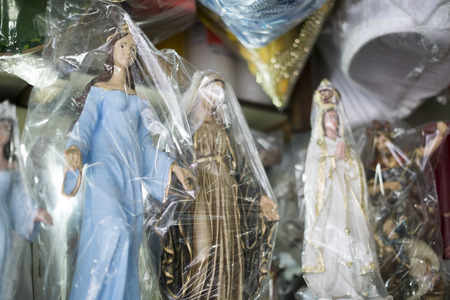BELO HORIZONTE, BRAZIL - JULY 28: Religious icons wrapped in plastic in Brazilian market. The saints are significant to Catholicism and African-Brazilian religions. July 28, 2014 in Belo Horizonte.のeditorial素材
