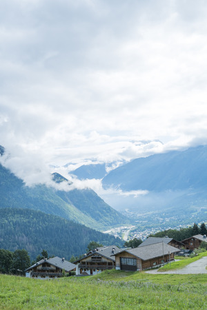 COL DE VOZA, FRANCE - AUGUST 24: Chalets with Les Houches village in the background. Les Houches is one of the Tour du Mont Blanc villages. August 24, 2014 in Col de Voza.のeditorial素材