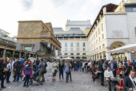 LONDON, UK - OCTOBER 05: Tourist observing artwork by artist Alex Chinneck in Covent Garden. The floating piazza will remain there until the end of the month. October 05, 2014 in London.のeditorial素材