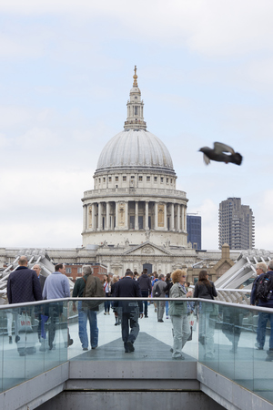 LONDON, UK - JUNE 23: Dome of Saint Paul's cathedral, with people crossing Millennium Bridge in the foreground. June 23, 2015 in London.のeditorial素材