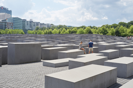 BERLIN, GERMANY - JULY 08: Young couple seated on stone block at the Memorial to the Murdered Jews...