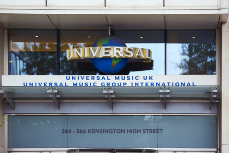 LONDON, UK - AUGUST 17: Woman approaching entrance of Universal Music Group International building in High Street Kensington. August 17, 2015 in London.のeditorial素材