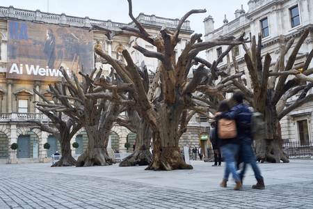 LONDON, UK - SEPTEMBER 23: Visitors appreciating Ai Wei Wei's installation 'Tree' in the forecourt of the Royal Academy of Arts. September 23, 2015 in London.のeditorial素材