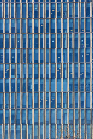 Close up cropped shot of skyscraper window frames in blue metal.
