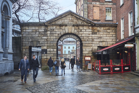 DUBLIN, IRELAND - JANUARY 05: Pedestrians walking in front of Dublin Castle gates. January 05, 2016 in Dublinのeditorial素材