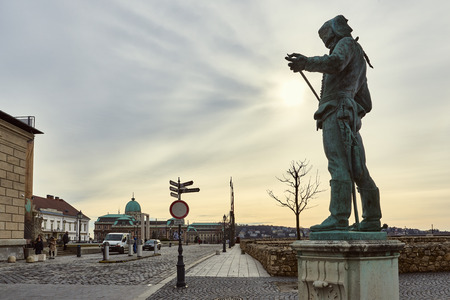 BUDAPEST, HUNGARY - FEBRUARY 02: Statue of a Hussar inspecting the edge of his sword, with Buda Castle in the background. February 02, 2016 in Budapest.のeditorial素材
