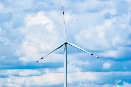Turbine on cloudy blue sky background