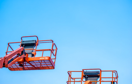 Basket crane on blue sky background
