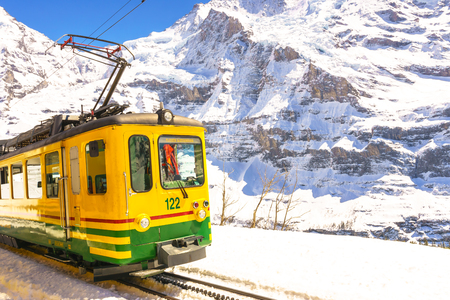 Jungfraujoch, Switzerland - April 29, 2017: Old style trains among the mountains near Kleine Scheidegg Station at Jungfrau, Switzerland.のeditorial素材