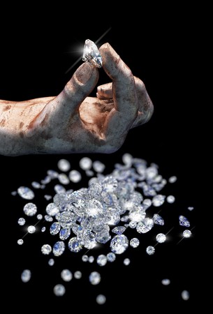 Diamonds on black surface and hand の写真素材
