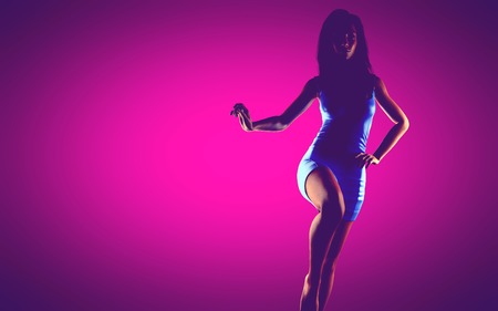 woman in dress at pink backgroundの写真素材