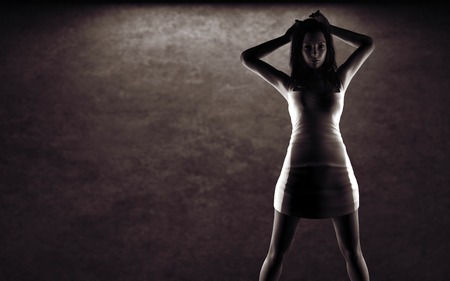 sexy woman in dress posing near stone wallの写真素材