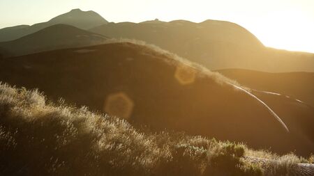 sunset over the valley fields near the hills