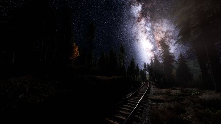 The milky way above the railway and forest