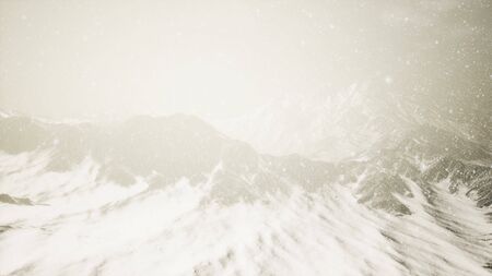 Heavy snowing, focused on the snowflakes, mountains in the backgroundの写真素材
