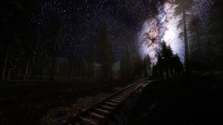 The milky way above the railway and forest