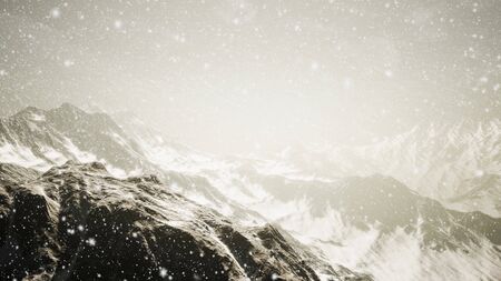 Heavy snowing, focused on the snowflakes, mountains in the backgroundの写真素材