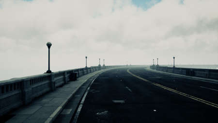 long bridge in misty fogの写真素材