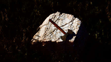 war ax for Viking on the rock at sunset