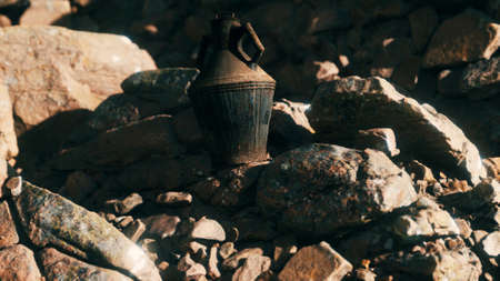 old metal jug at rocksの写真素材