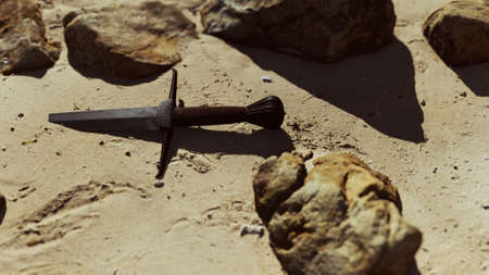 retro sword on sand beachの写真素材