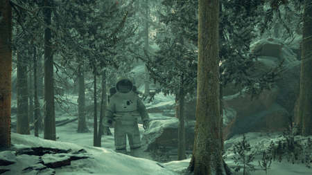 Astronaut exploring forest in snowの写真素材