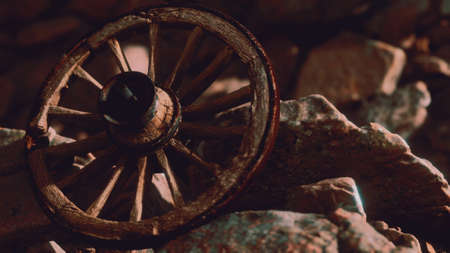 old wooden wheel on rocksの写真素材