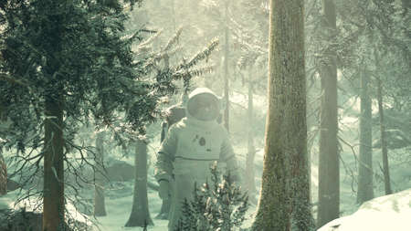 Astronaut exploring forest in snowの写真素材