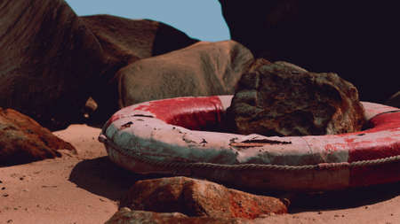 old broken lifebuoy on sea beach