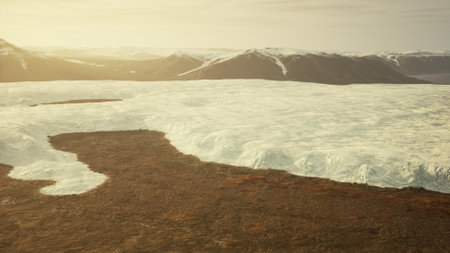 An aerial view of a glacier with mountains in the background