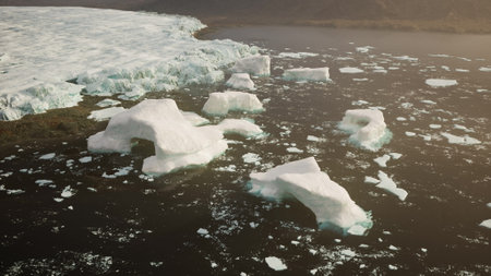 A group of icebergs floating on top of a body of water