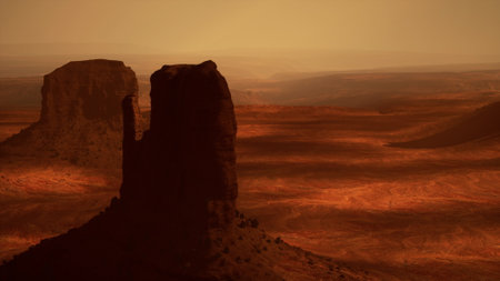 A Majestic Rock Formation Rising Above the Desert Sandsの写真素材