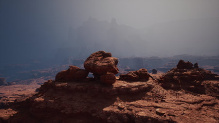 A rock formation stands in the vast desert landscape under the scorching sun.の写真素材