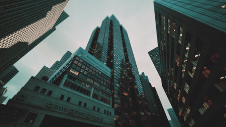 Witness the awe-inspiring sight of towering skyscrapers as you gaze upwards at this vibrant cityscape.の写真素材