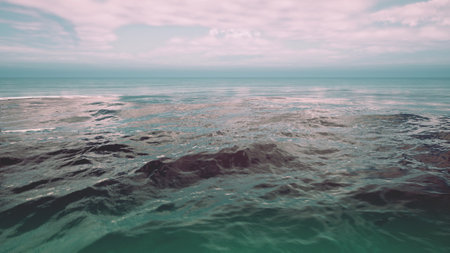 Calm sea waters under a gradient twilight sky, reflecting the tranquil mood of evening.の写真素材